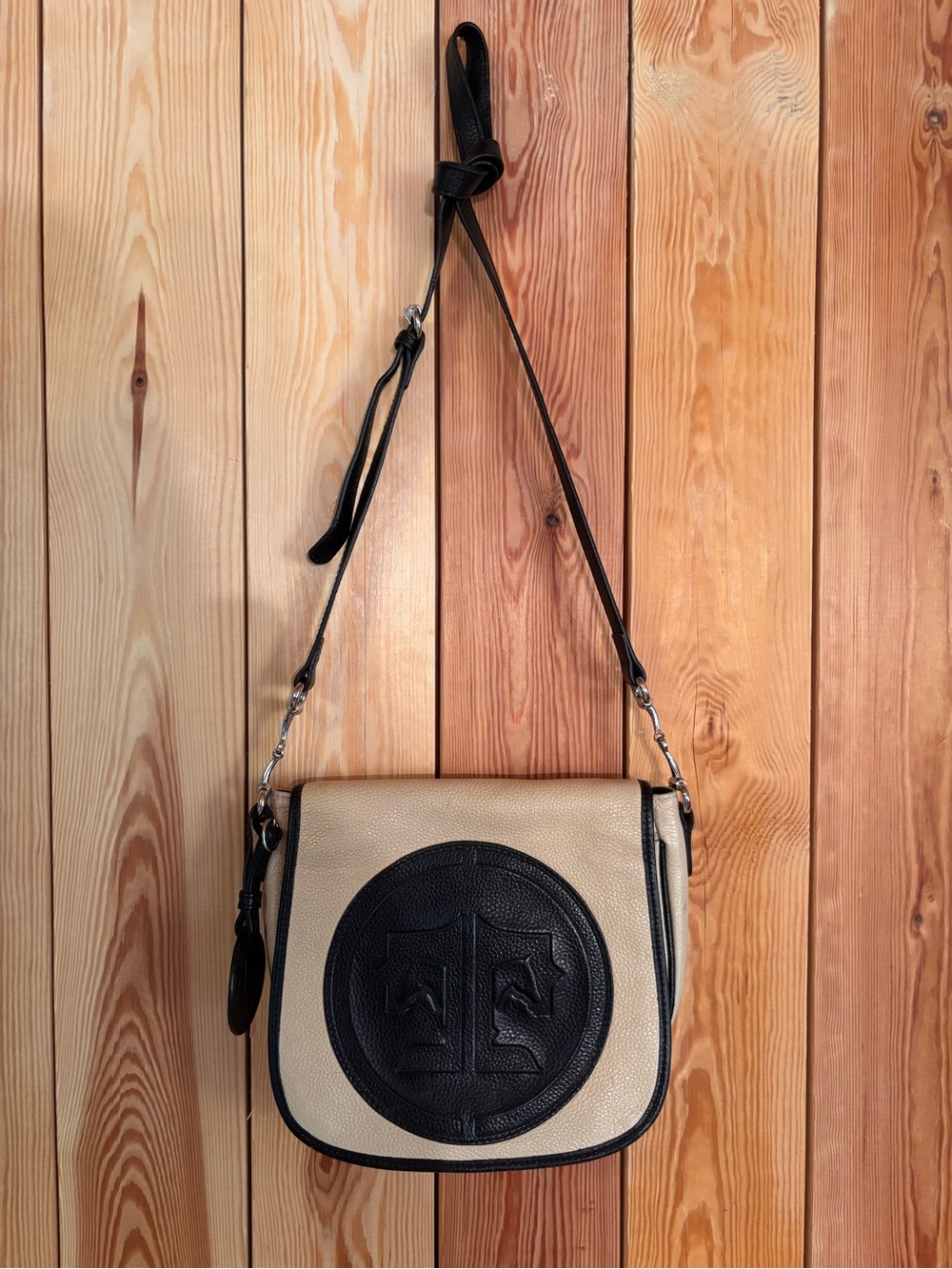 Beige and Black Crossbody Bag with Embossed Medallion